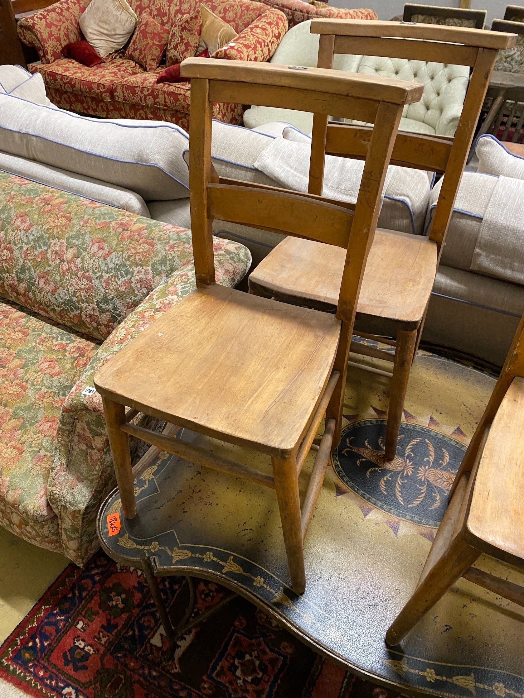 A set of four beech chapel chairs